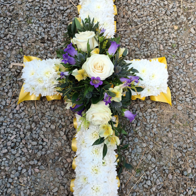 Cross SYM-329 - This classic 120cm cross is made using massed white flowers, complemented with a red and blue spray.