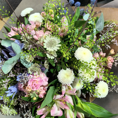 Hidden Treasure - An outstanding hand tied bouquet with a cascade of colour and a treasure chest overflowing with the beautiful flowers.