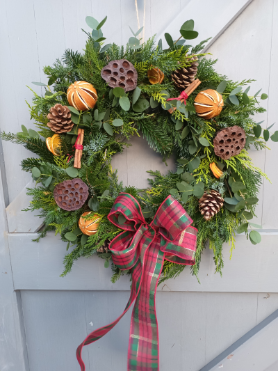 Door garland - A beautiful spruce and holly wreath to adorn a door including cinnamon sticks, lotus heads, and cones with a  bow....your choice of colour!  Available from 23rd November.